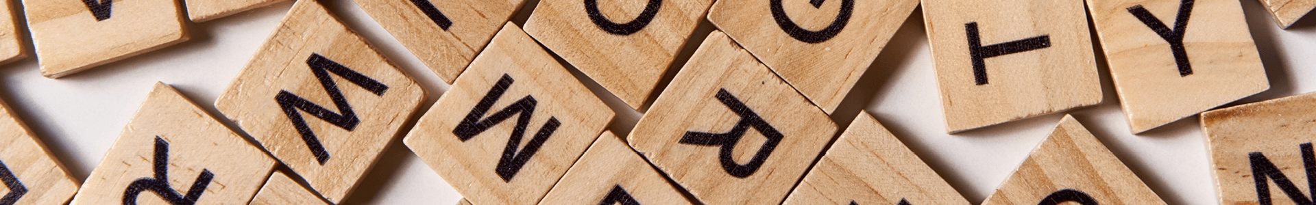 A pile of wooden blocks that each have a letter on them